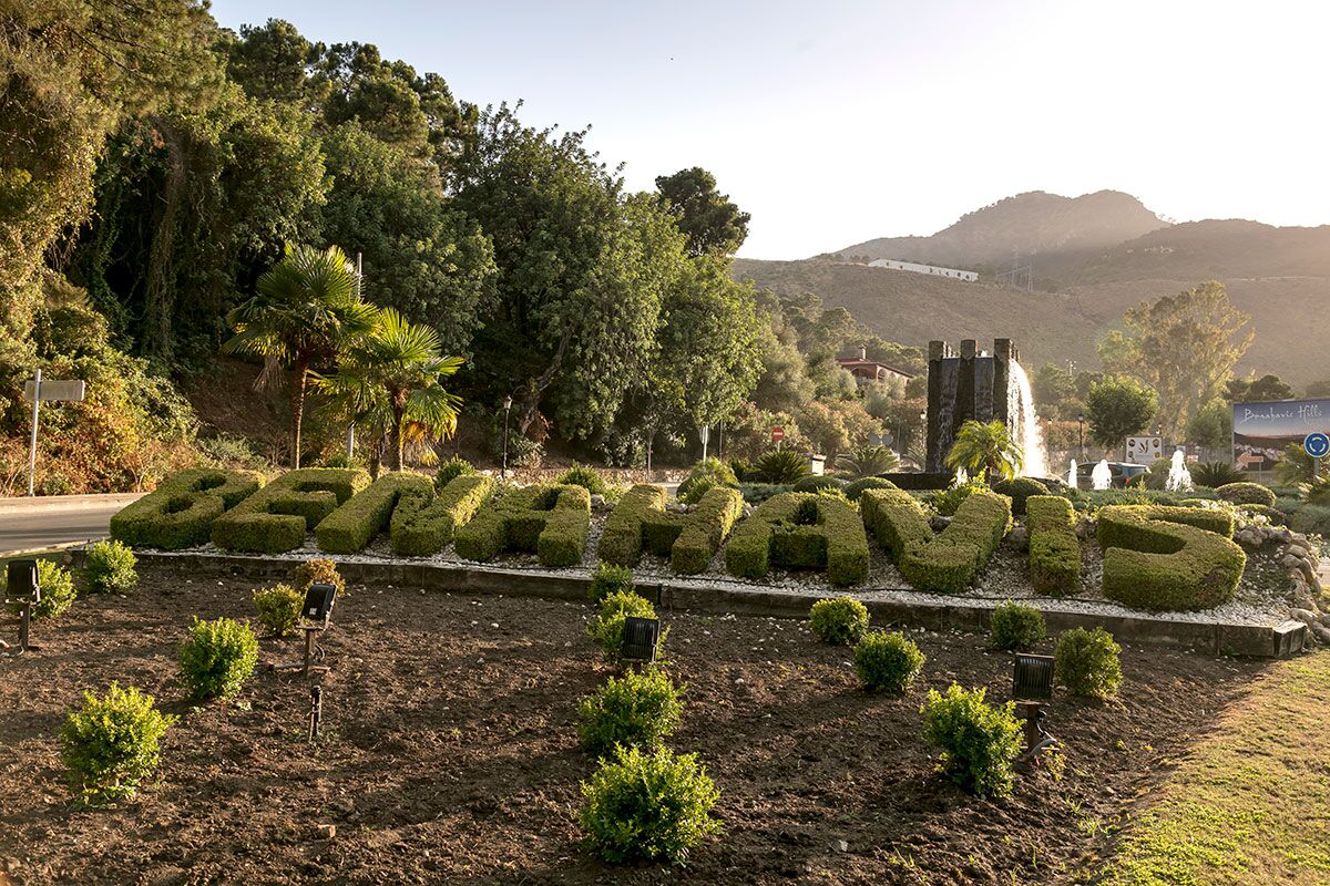 Entrance to Benahavis sign pruned in hedge